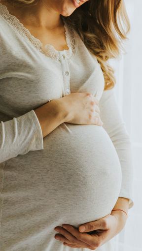 Woman holding pregnant stomach